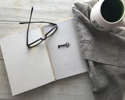 An open book on a wooden desk